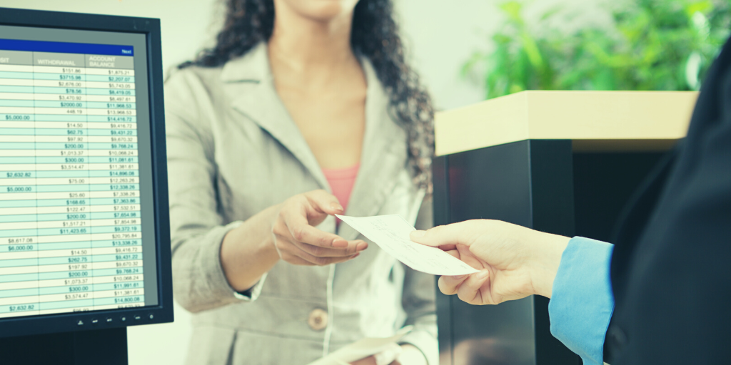 A woman interacting with a bank teller