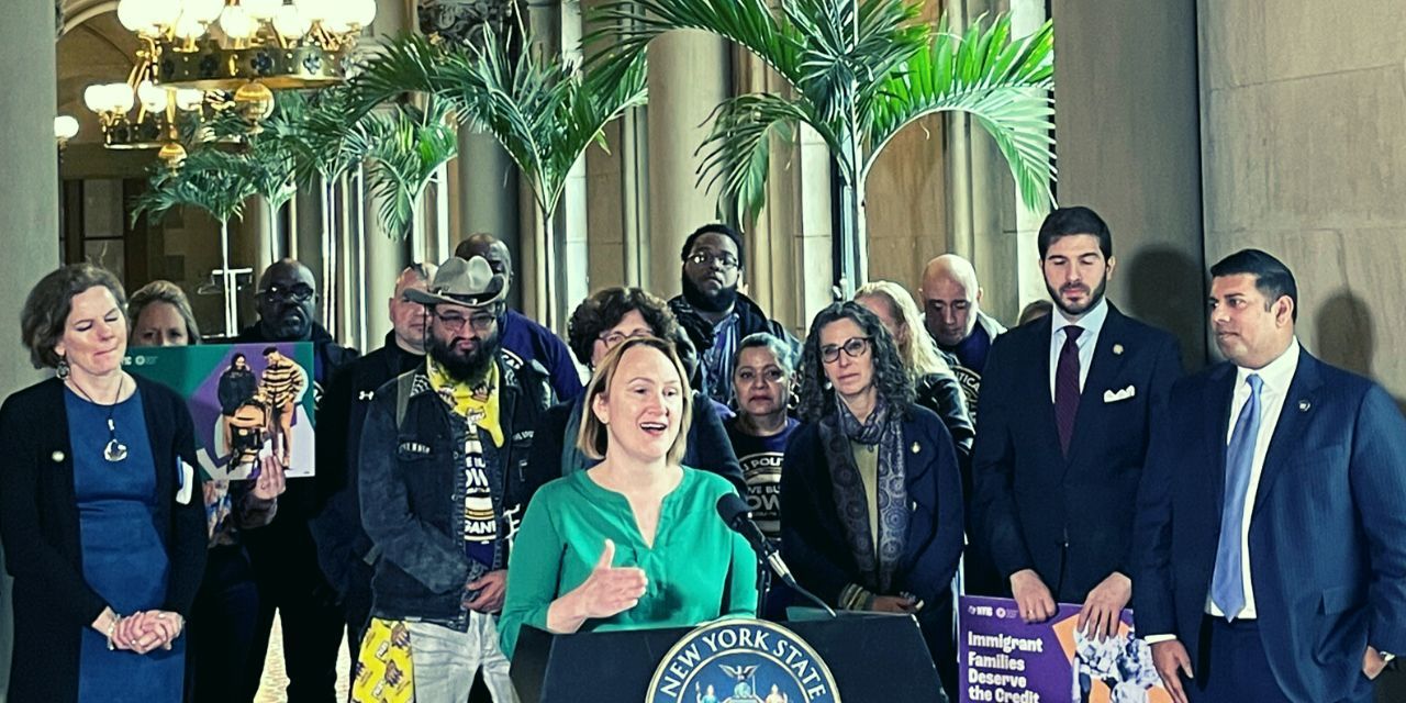 Kristin Brown speaking at press conference outside the NYS Senate Chambers. She is flanked by other advocates and legislators.