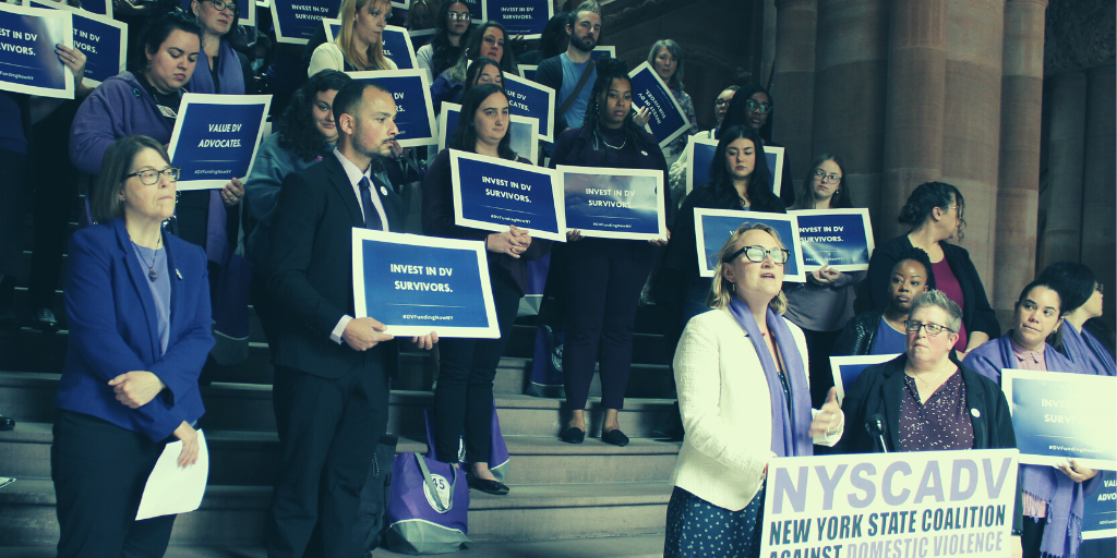 Kristin Brown speaking in front of advocates on the Million Dollar Staircase in the NYS Capitol.
