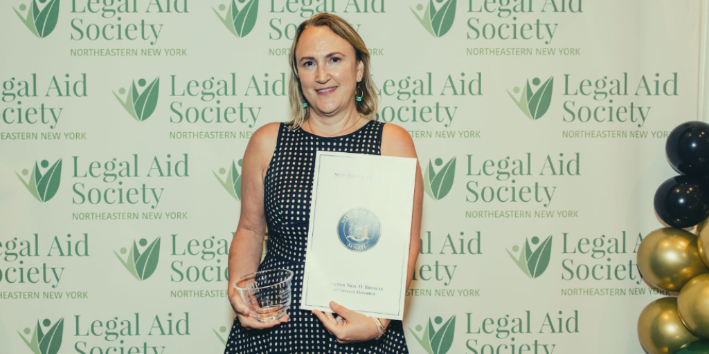 Kristin Brown at the LASNNY 100 year Gala, holding her award.